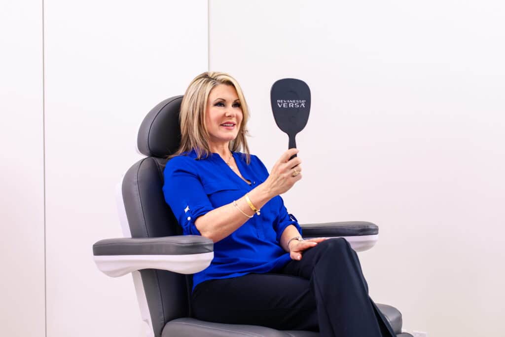 Woman with mirror at Dr Philip Miller facial plastic surgeon